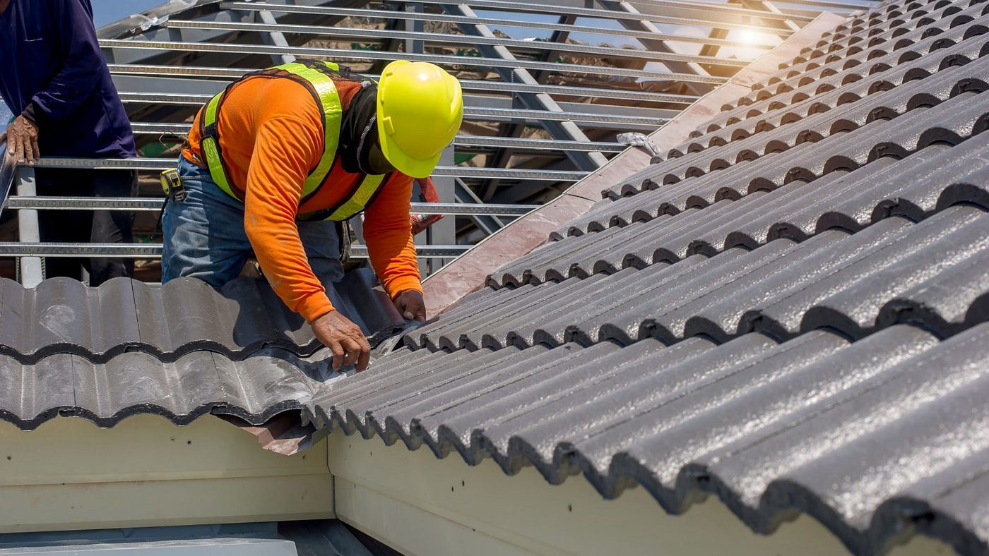 Roofer repairing a metal roof.